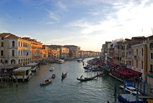 Italy; Venice. The bustling riverfront along the Grand Canal in Venice at sunrise