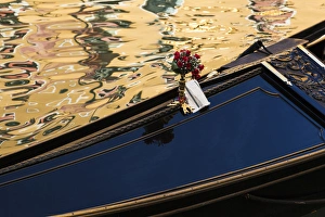 Italy, Venice. A gondola detail and colorful water reflections Italy, Venice. A gondola detail and colorful water reflections
