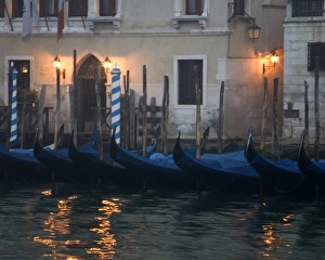 Italy, Venice. Gondolas moored in front of hotel in early morning light Italy, Venice. Gondolas moored in front of hotel in early morning light