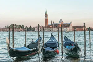 Italy, Venice. Gondolas on the waterfront with San Giorgio Maggiore Church in the Italy, Venice. Gondolas on the waterfront with San Giorgio Maggiore Church in the