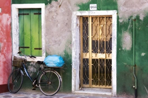 Italy, Venice. An old bicycle leans against a weathered house on the island of Burano Italy, Venice. An old bicycle leans against a weathered house on the island of Burano