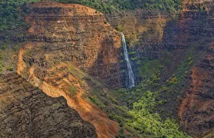 Kauai Hawaii scenic Waimea Canyon State Park red cliffs from above canyon with distant Kauai Hawaii scenic Waimea Canyon State Park red cliffs from above canyon with distant