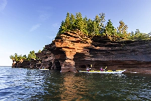 Kayakers exploring the sea caves of Devils Island in the Apostle Islands National Kayakers exploring the sea caves of Devils Island in the Apostle Islands National