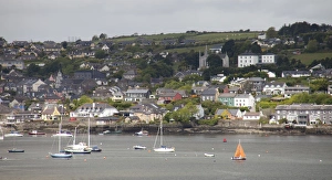 Kinsale Ireland with colorful homes on the hillside and boats in the water Kinsale Ireland with colorful homes on the hillside and boats in the water