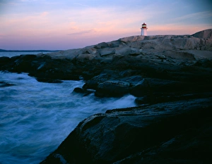 The lighthouse at Peggys Cove on the southern coast of Nova Scotia, Canada with waves The lighthouse at Peggys Cove on the southern coast of Nova Scotia, Canada with waves
