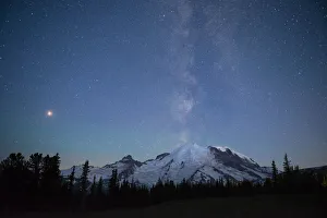 The lights of climbers can be seen on the mountain as the Milky Way rises behind Mt The lights of climbers can be seen on the mountain as the Milky Way rises behind Mt