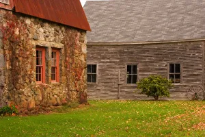 Maine, Old stone building and wooden barn in fall in rural New England Maine, Old stone building and wooden barn in fall in rural New England