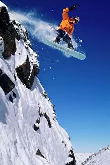 Images Dated 12th June 2009: Man on a snowboard jumping off a cornice at Snowbird Resort in Little Cottonwood