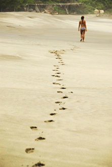 Mexico, Mazunte, view of footprints of woman in bikini walking on sand at the beach Mexico, Mazunte, view of footprints of woman in bikini walking on sand at the beach