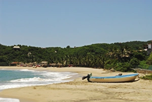 Mexico, Mazunte, view of a nautical vessel moored on sand at the shore of the beach with Mexico, Mazunte, view of a nautical vessel moored on sand at the shore of the beach with