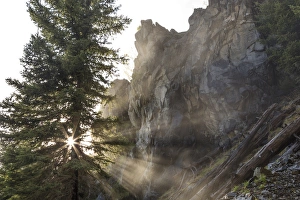 Mist from Holland Falls is backlit by setting sun in the Lolo National Forest, Montana Mist from Holland Falls is backlit by setting sun in the Lolo National Forest, Montana