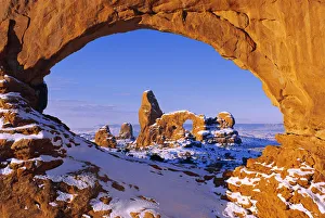 Morning light on North Window framing Turret Arch in winter, Arches National Park, Utah Morning light on North Window framing Turret Arch in winter, Arches National Park, Utah
