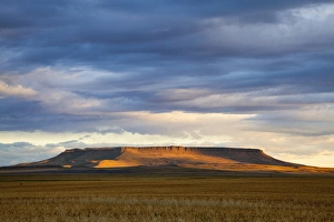 Morning sunlight breaks through the cloud cover and illuminates Square Butte near Great Morning sunlight breaks through the cloud cover and illuminates Square Butte near Great