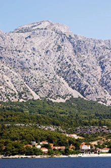 Mountain top of the Mount Sveti Ilija, with white rock formations. At sea level the Orebic village Mountain top of the Mount Sveti Ilija, with white rock formations. At sea level the Orebic village