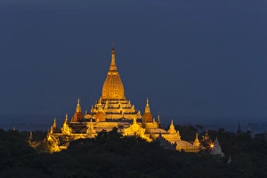 Myabnmar, Bagan. A giant stupa is lit at night on the plains of Bagan Myabnmar, Bagan. A giant stupa is lit at night on the plains of Bagan