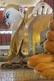 Myanmar. Yangon. Chauk Htat Gyi Pagoda. Monk cleaning a giant reclining Buddha Myanmar. Yangon. Chauk Htat Gyi Pagoda. Monk cleaning a giant reclining Buddha