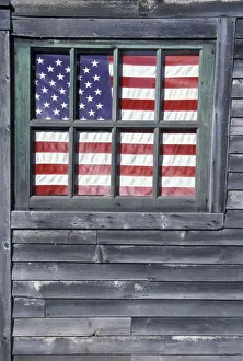NA, USA, Maine, Georgetown Island. Flag of the United States in window of abandoned store NA, USA, Maine, Georgetown Island. Flag of the United States in window of abandoned store