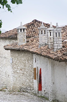 Narrow cobble stone street with traditional ottoman white stone houses. An Albanian Narrow cobble stone street with traditional ottoman white stone houses. An Albanian