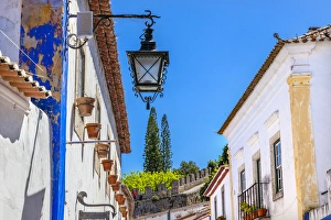 Narrow White Street 11th Century Castle Wall Medieval Town Lamp Obidos Portugal. Castle Narrow White Street 11th Century Castle Wall Medieval Town Lamp Obidos Portugal. Castle