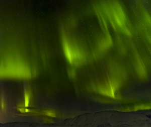 Northern Lights or aurora borealis over the mountains between Thingvellir and Laugarvatn