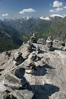 Images Dated 4th July 2009: Norway, Geiranger. Travelers stone stacks with a view of the port of Geiranger from Mt