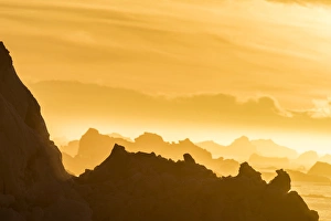 Norway, Svalbard, Nordaustlandet. Silhouette of icebergs backlit at sunset. Credit as Norway, Svalbard, Nordaustlandet. Silhouette of icebergs backlit at sunset. Credit as
