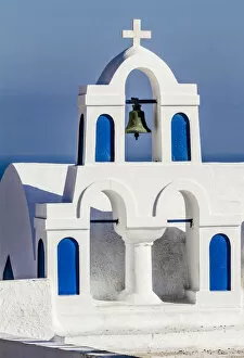 Aegean Sea Gallery: Oia, Greece. Greek Orthdox Church steeple, cross, bell, and blue arches against Aegean