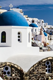 Oia, Greece. Row of Greek Orthdox Churches with blue domes and painted pastel white Oia, Greece. Row of Greek Orthdox Churches with blue domes and painted pastel white