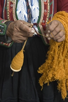 Old woman in traditional dress and hat spinning wool, Chinchero, Department of Cuzco, Peru Old woman in traditional dress and hat spinning wool, Chinchero, Department of Cuzco, Peru