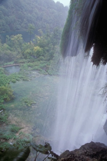 Overlooking the area below from behind a waterfall at Plitvice Lakes National Park Croatia Overlooking the area below from behind a waterfall at Plitvice Lakes National Park Croatia