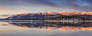 Panoramic of Big Mountain reflects into Whitefish Lake at sunset in winter in Whitefish Panoramic of Big Mountain reflects into Whitefish Lake at sunset in winter in Whitefish