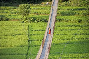 People crossing suspension bridge over Trishuli River, Tupche, Nuwakot District People crossing suspension bridge over Trishuli River, Tupche, Nuwakot District
