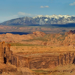 Photo taken from Long Canyon with badlands and snow capped La Sal Mountains in distance Photo taken from Long Canyon with badlands and snow capped La Sal Mountains in distance