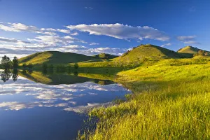 Pond reflects at days end in the Bears Paw Mountains near Havre, Montana, USA Pond reflects at days end in the Bears Paw Mountains near Havre, Montana, USA