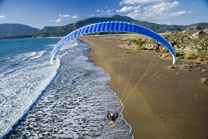 Powered paraglider flying over beach in Dalyan, aerial view, Koycegiz, Mugla, Turkey Powered paraglider flying over beach in Dalyan, aerial view, Koycegiz, Mugla, Turkey
