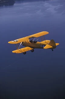 Images Dated 3rd December 2004: P.R. Yellow Biplane, 1944 Stearman PT-17, flying over Puget Sound, WA