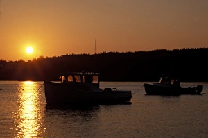 Pretty Marsh, ME. The sun sets over the harbor on Mt. Desert Island. Clouds. Boats Pretty Marsh, ME. The sun sets over the harbor on Mt. Desert Island. Clouds. Boats