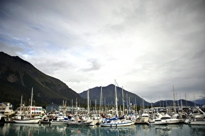 Private and Commercial Boats lie in Seward harbor amongst breaking skies Private and Commercial Boats lie in Seward harbor amongst breaking skies