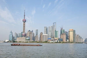 Images Dated 26th May 2012: Pudong district skyline with shipping on the Huangpu River Shanghai, China