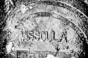 Rain covered manhole cover in Missoula, Montana Rain covered manhole cover in Missoula, Montana