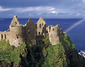 A rainbow strikes medieval Dunluce Castle on the Antrim Coast in Co. Antrim in Northern Ireland A rainbow strikes medieval Dunluce Castle on the Antrim Coast in Co. Antrim in Northern Ireland