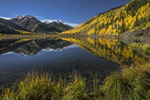 Red Mountain and autumn aspen trees reflected on Crystal Lake at sunrise, near Ouray Red Mountain and autumn aspen trees reflected on Crystal Lake at sunrise, near Ouray