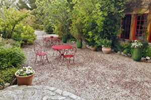 Red tables and chairs in outdoor sitting area, Provence region of southern France Red tables and chairs in outdoor sitting area, Provence region of southern France