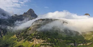 Rolling fog clouds with Heavy Runner and Reynold Mountains at Logan Pass in Glacier National Park, USA Rolling fog clouds with Heavy Runner and Reynold Mountains at Logan Pass in Glacier National Park, USA