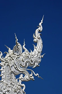 Rooftop architectural detail of dragon head on the new all white temple of Wat Rong Rooftop architectural detail of dragon head on the new all white temple of Wat Rong