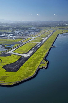 Runway at Auckland Airport, and Manukau Harbour, North Island, New Zealand - aerial Runway at Auckland Airport, and Manukau Harbour, North Island, New Zealand - aerial