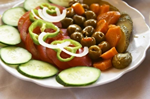 Salad with tomatoes, onions, green bell peppers, cucumbers, cornichons olives and carrots Salad with tomatoes, onions, green bell peppers, cucumbers, cornichons olives and carrots