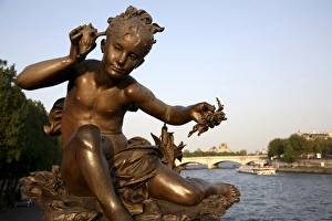 The sculpture on the Pont Alexandre III with River Seine in the background. Paris. France The sculpture on the Pont Alexandre III with River Seine in the background. Paris. France