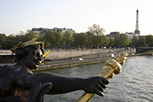 The sculpture on the Pont Alexandre III with River Seine and Eiffel Tower in the background The sculpture on the Pont Alexandre III with River Seine and Eiffel Tower in the background