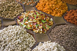 Selling nuts and dried fruit at the market, Dubai, UAE Selling nuts and dried fruit at the market, Dubai, UAE